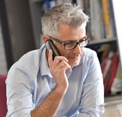 Older man talking on the phone.