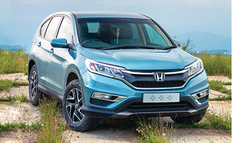 Blue car in mountain landscape.