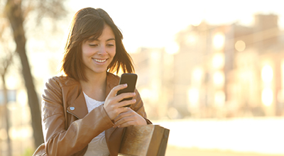 A woman using her smartphone outdoors.